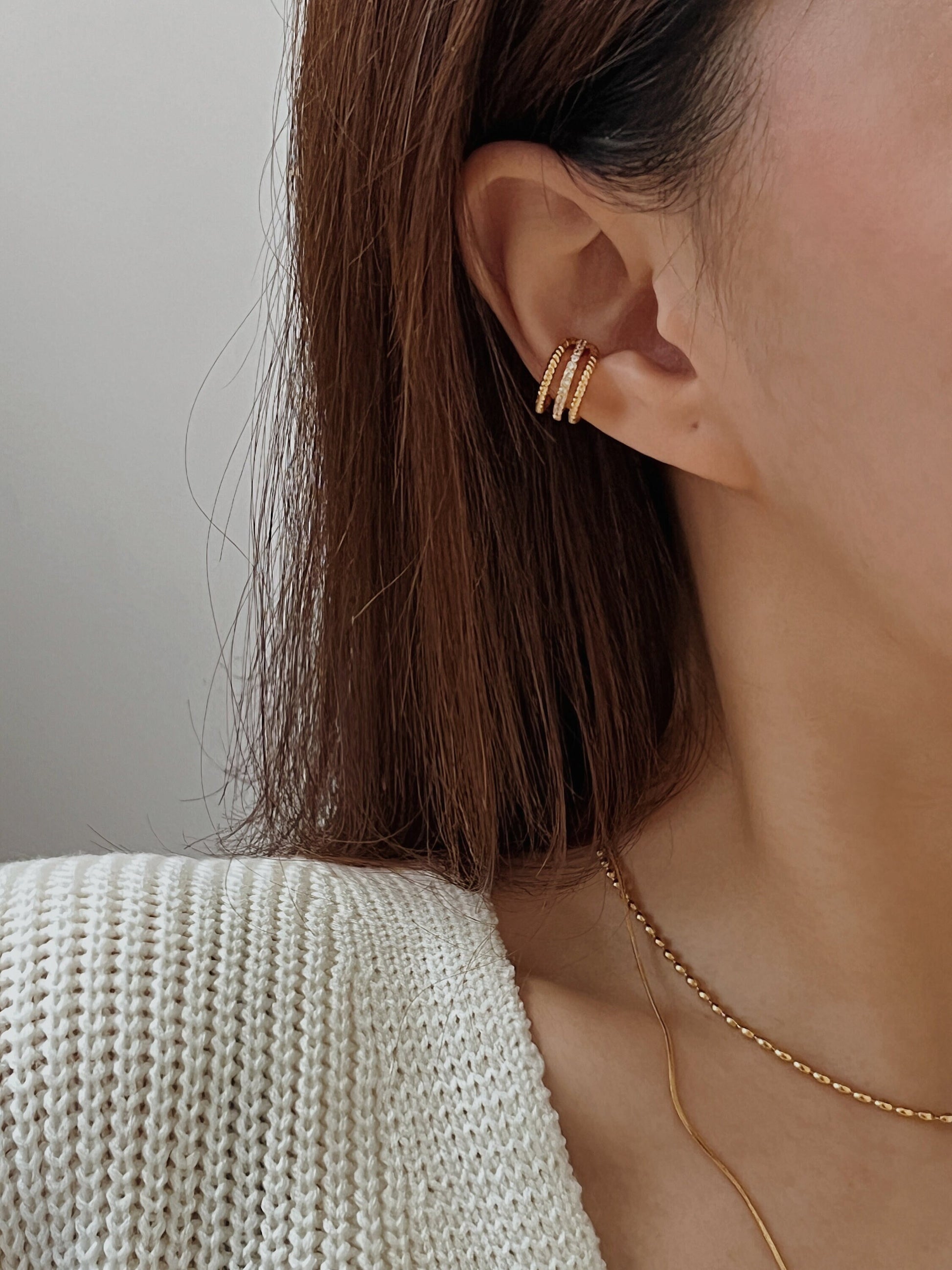 Model wearing Jennie triple band cuff on helix.