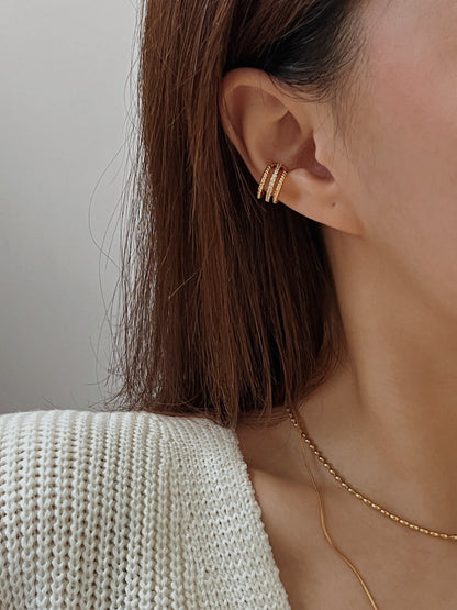 Model wearing Jennie triple band cuff on helix.