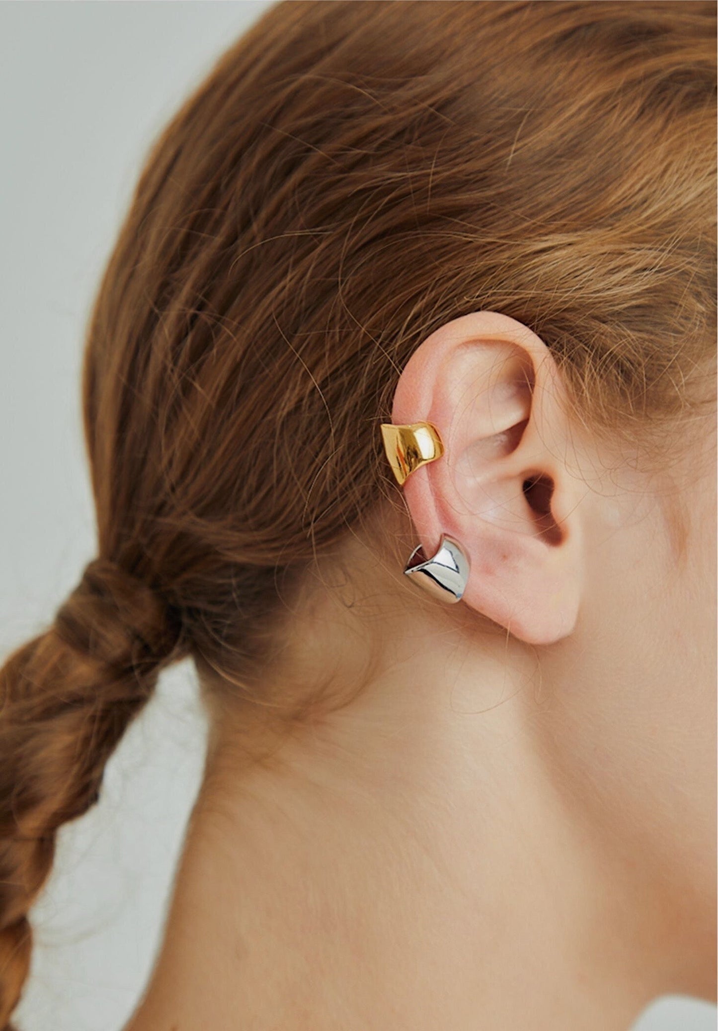 Model wearing Jil wide cuff on helix.