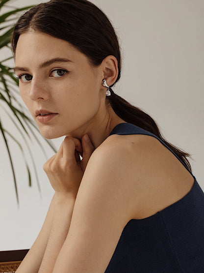 Side profile of Lisa Teardrop Earrings styled with a blue top.