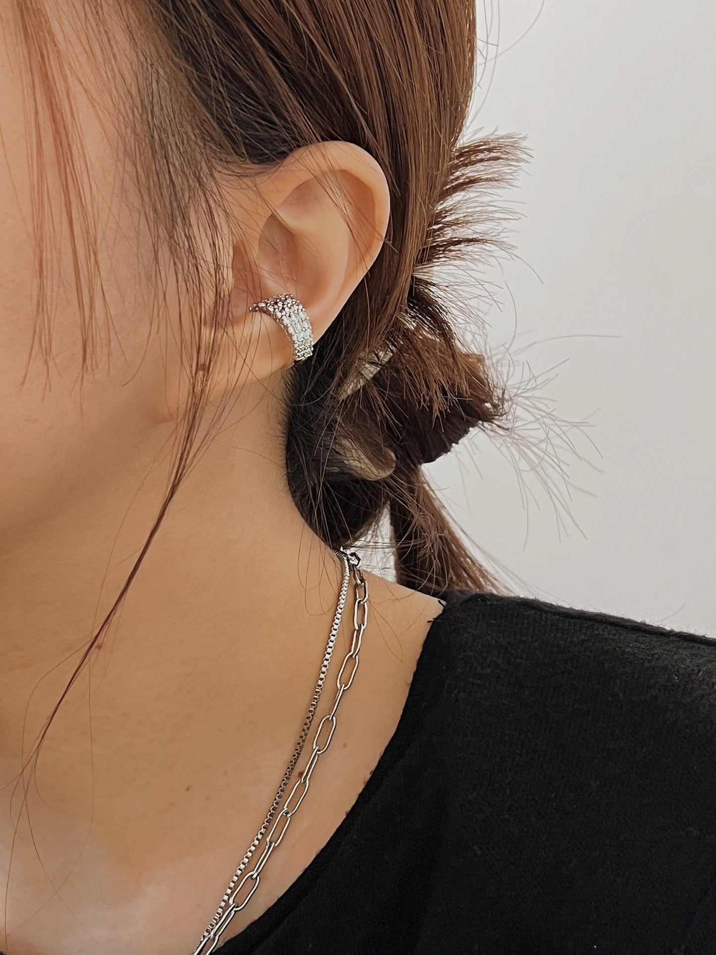 Close-up of model's ear showing the secure fit of the Emily cuff