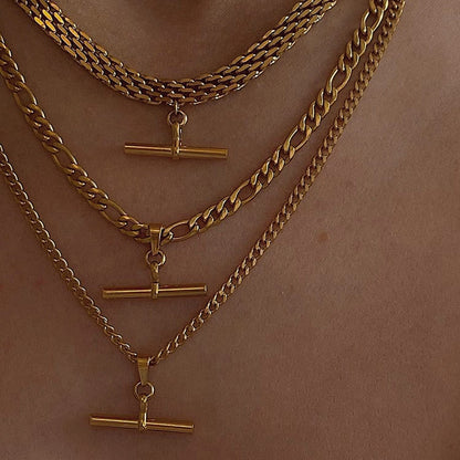 Model chest view styling multiple layered gold T bar pendant necklaces over skin