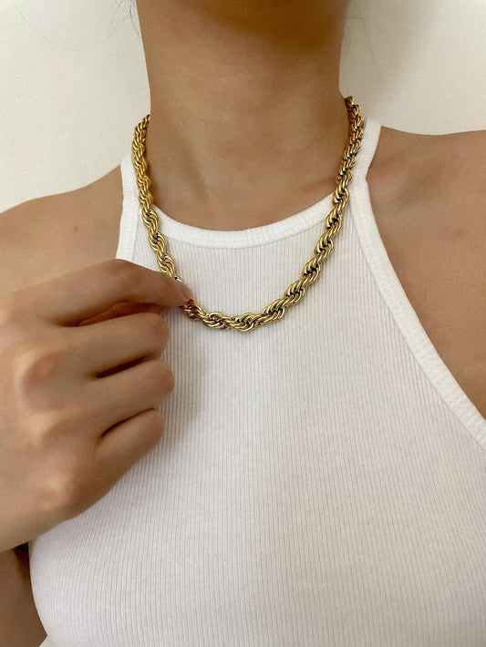 Model collarbone view styling the chelsea bold twisted rope chain over a white ribbed tank top
