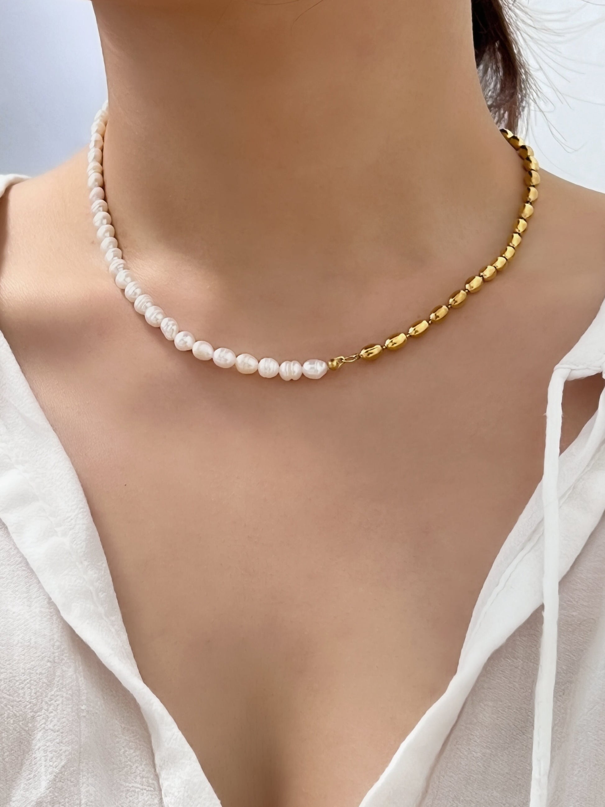 Model collarbone view styling the colette half pearl bead choker with an open linen top