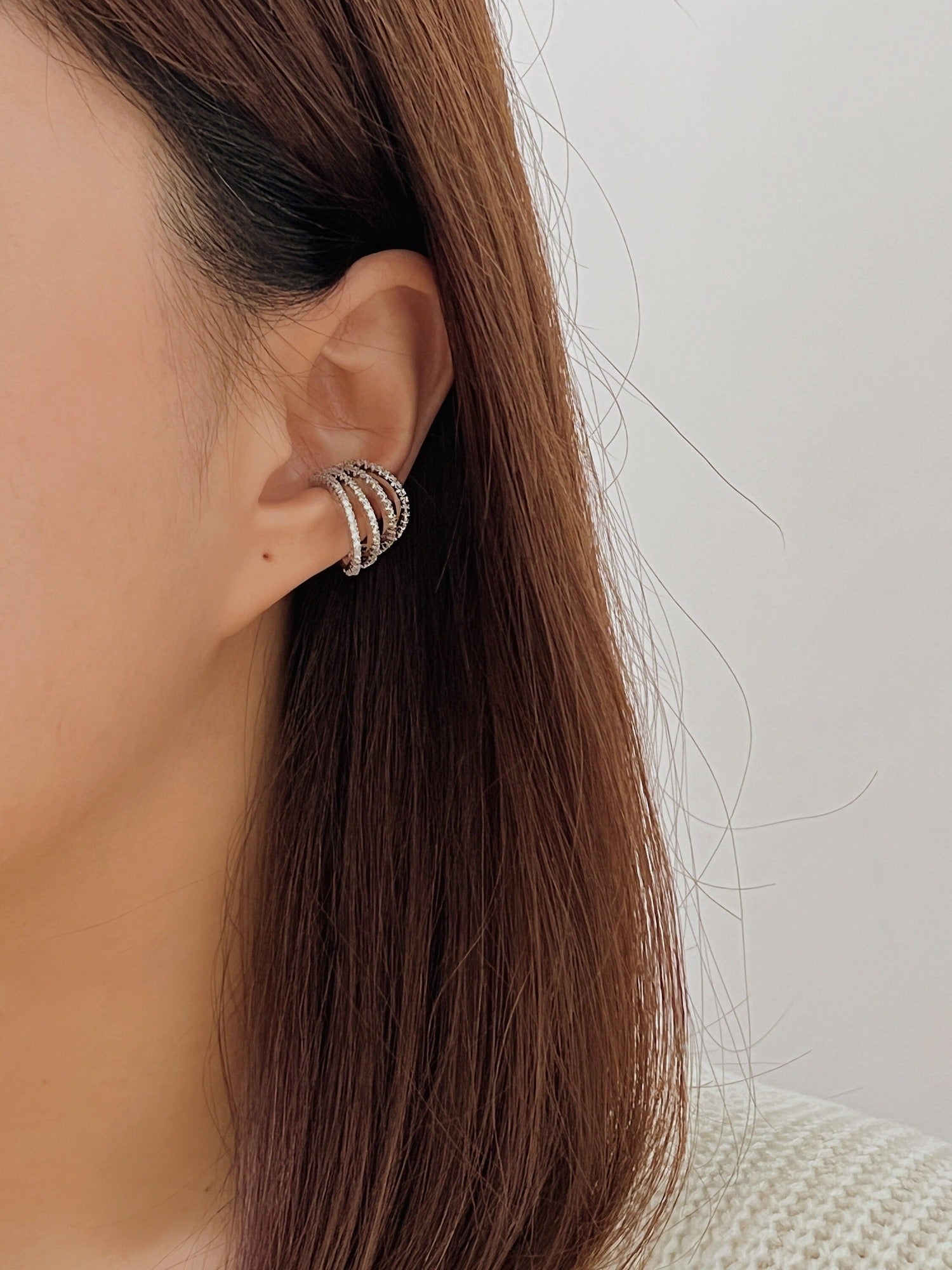 Model wearing Aurelia cuff, high-fashion multi-hoop stack.