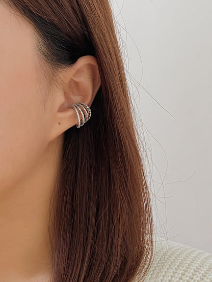 Model wearing Aurelia cuff, high-fashion multi-hoop stack.