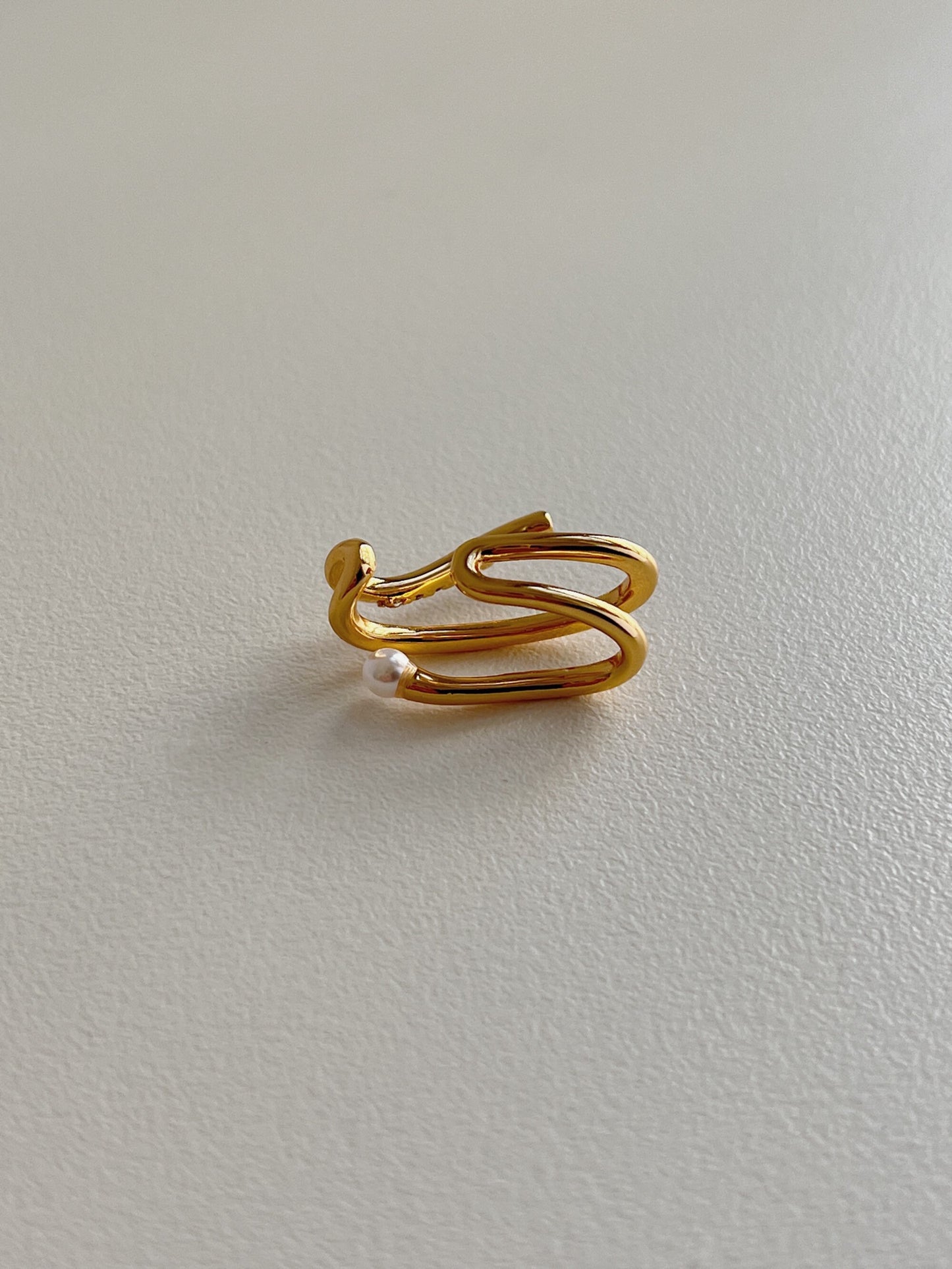Top-down view of Heidi waterproof pearl ear cuff.