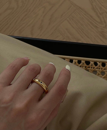 Hand styling a bold CZ gold statement ring on the middle finger