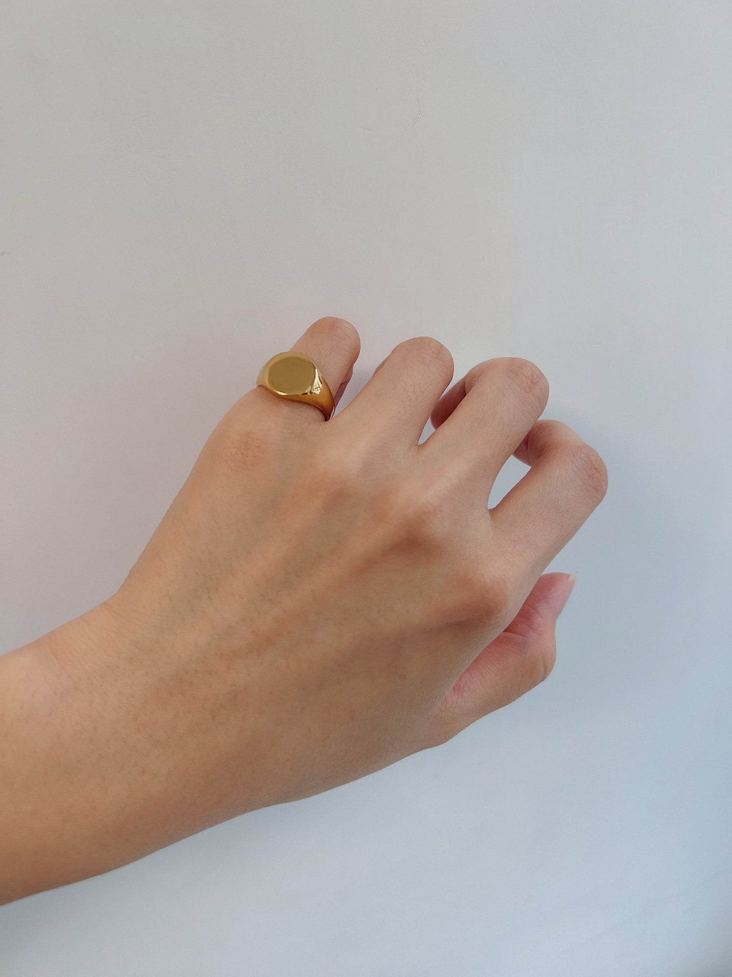 Model wearing the Brett gold signet ring on the pinky finger for a minimalist look