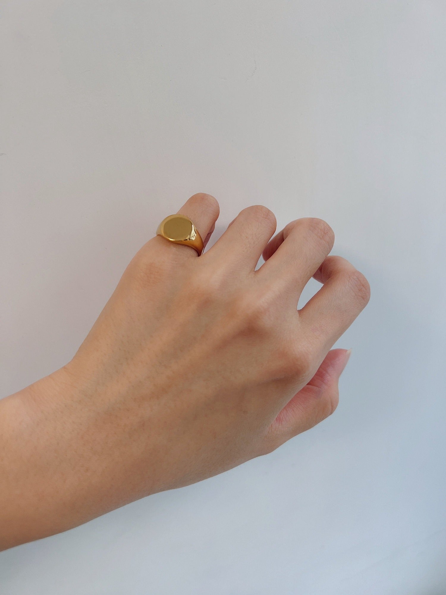 Model wearing the Brett gold signet ring on the pinky finger for a minimalist look