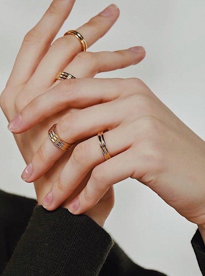 Editorial photography of gold ribbed rings showcasing mirror luster