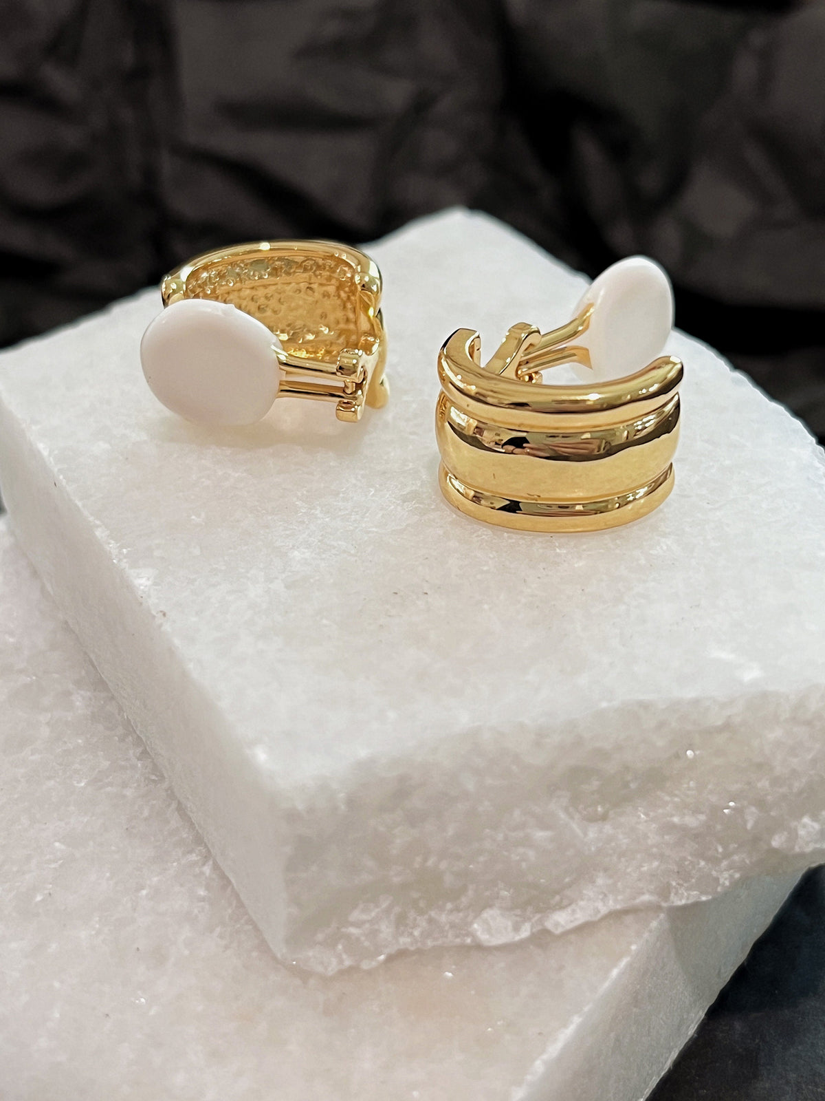 Close up shot of white silicone cushion pad on spring-hinged clip-on backing of Molly earring