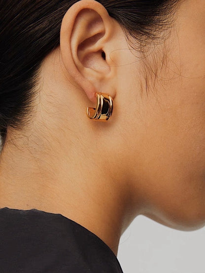 Close-up side profile of model wearing gold Molly vintage ribbed clip-on earring on unpierced earlobe