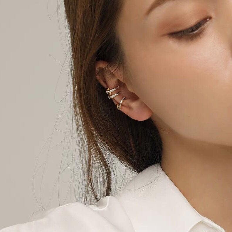 Model wearing Mandy thick and slim pave ear cuff in the conch for a bold look.