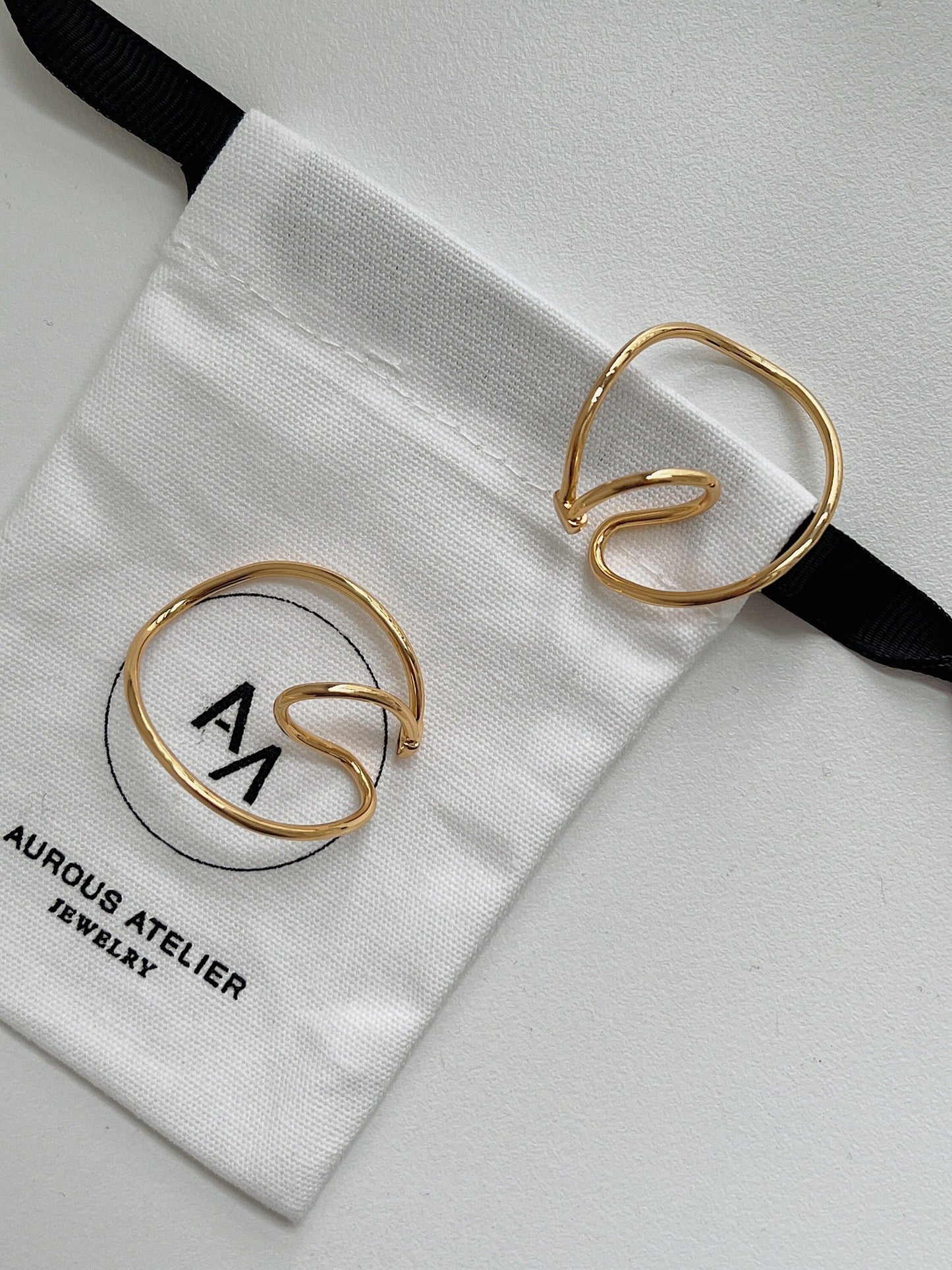 Kendra Gold Ear Cuff Set displayed on an Aurous Atelier jewelry pouch.