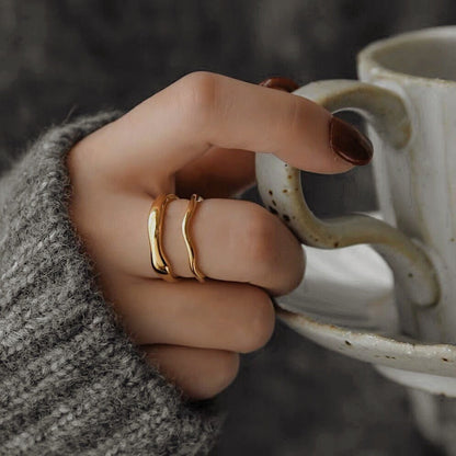 Model wearing thick and slim Ida rings stacked together on middle finger.