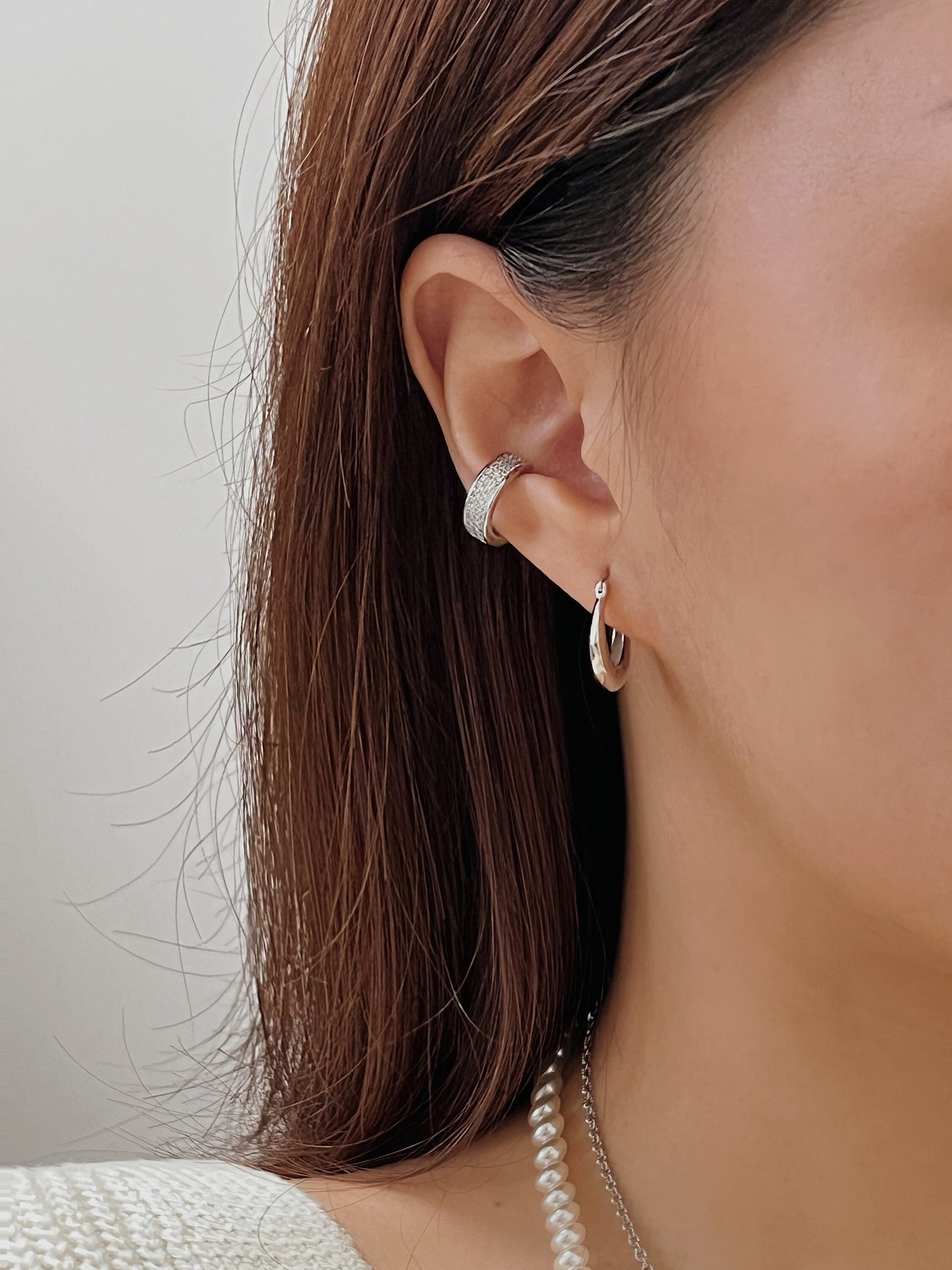 Priscilla Cuff styled with a white knit sweater for a daily look.