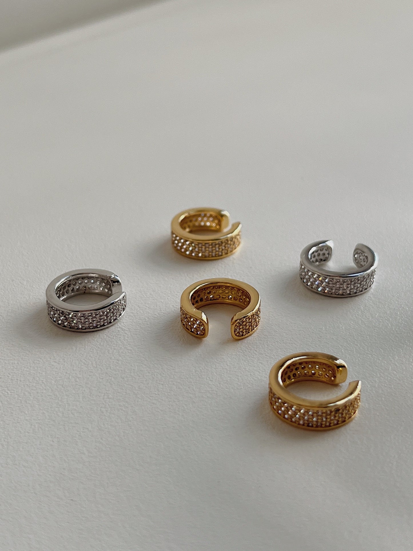 Silver and Gold Thick Pave Ear Cuff with cubic zirconia stones top down view.
