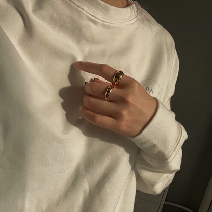 Sculptural gold dome rings styled for an casual look