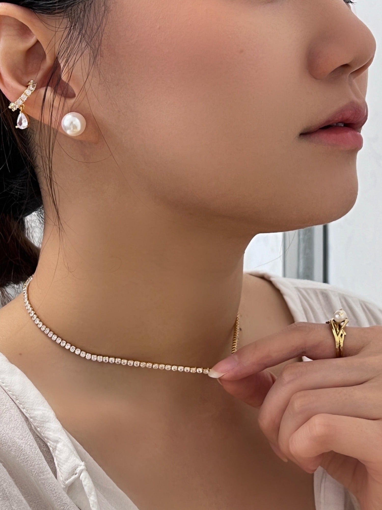 Close up of a professional woman wearing skin safe nickel free clear crystal jewelry