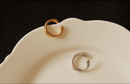 Gold and Silver Leia Cuffs on a white plate showing liquid metal design