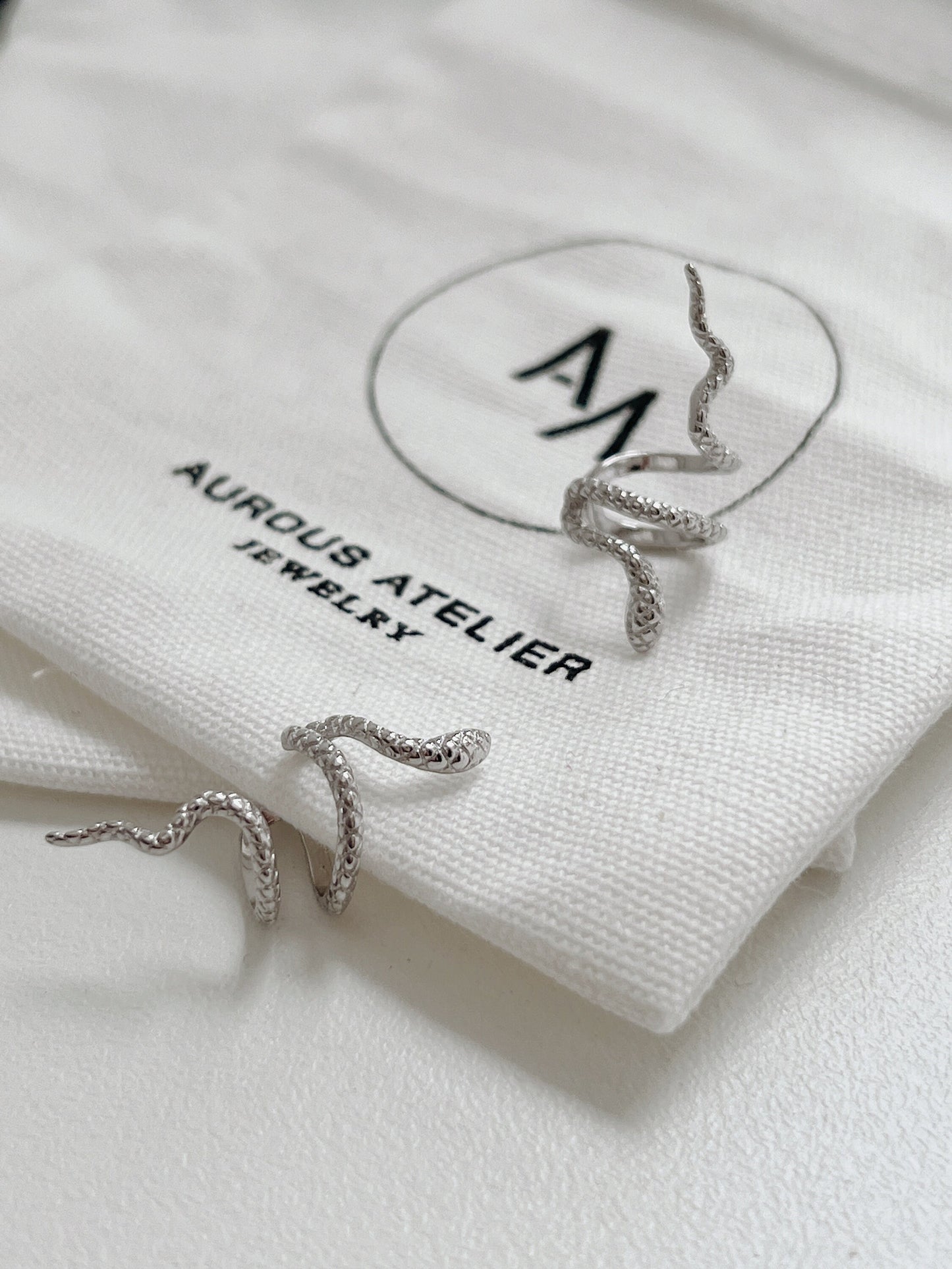 Top-down view of Victoria sculptural silver ear cuff.