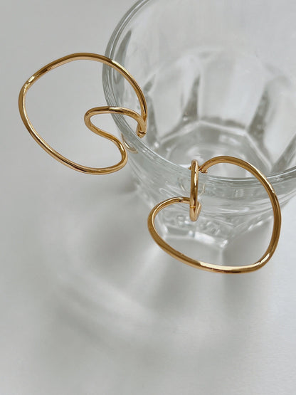 Close-up of the fluid, architectural curves of the Kendra Gold Cuff.