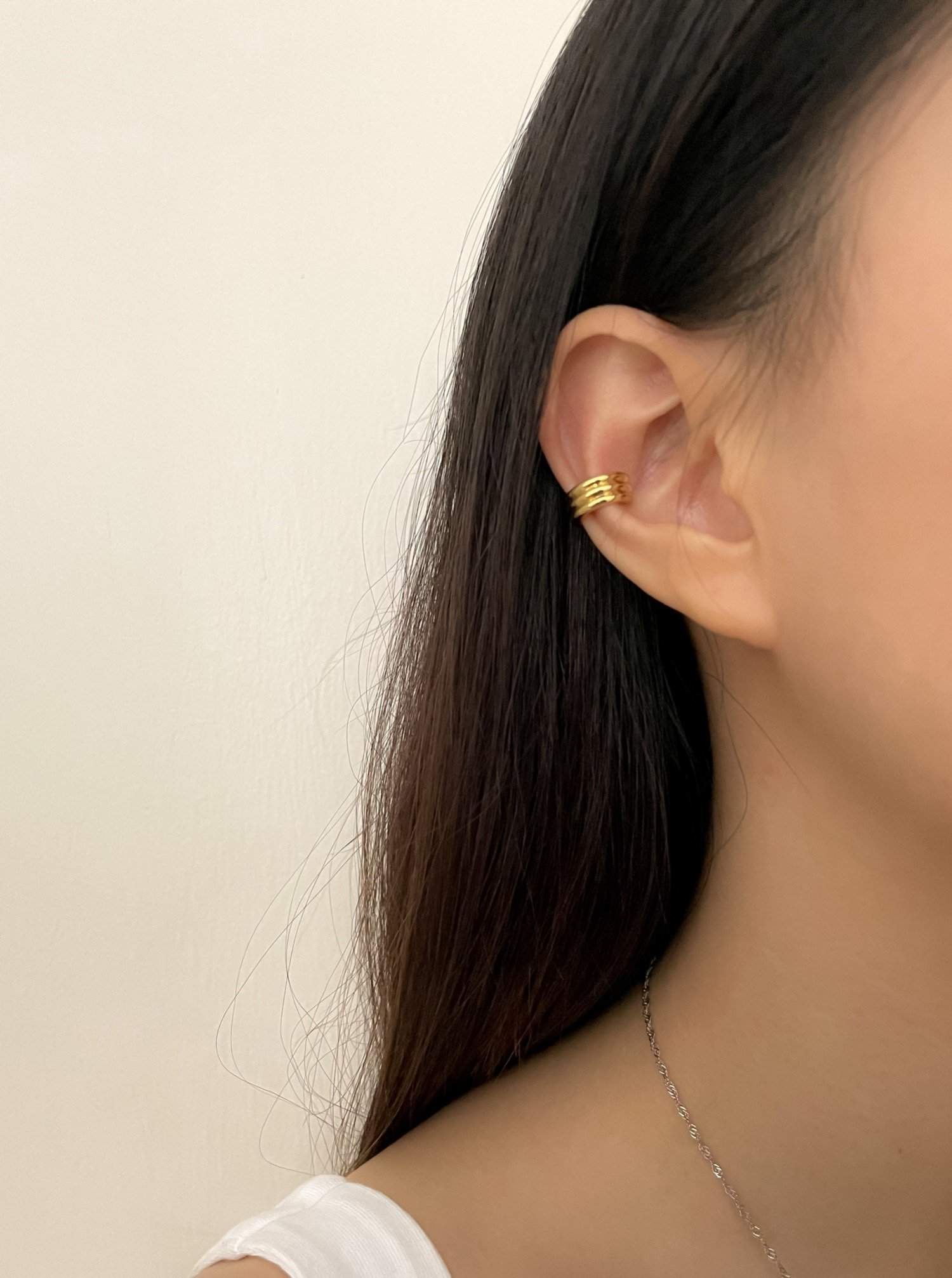 Fashion model wearing the Elena cuff as a standalone statement ear piece.