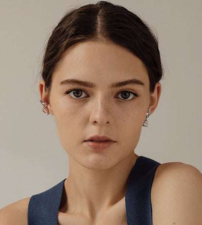 Model styling a set of Lisa Silver Cuff on mid-helix with sleek low pony hair.
