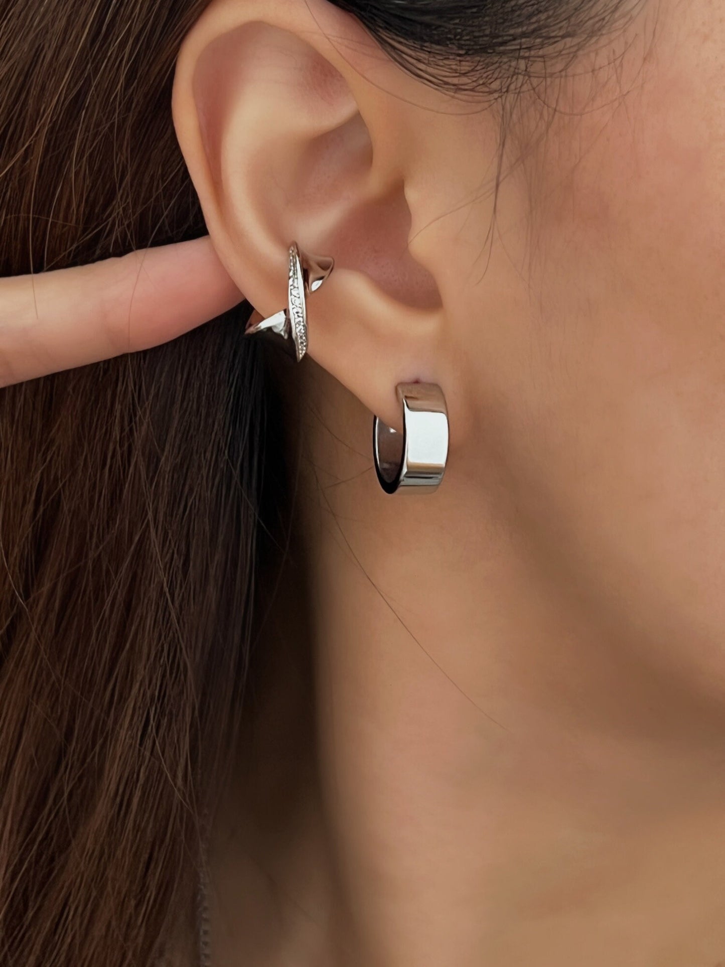 Side profile featuring Evelyn cuff styled with minimalist hoops.