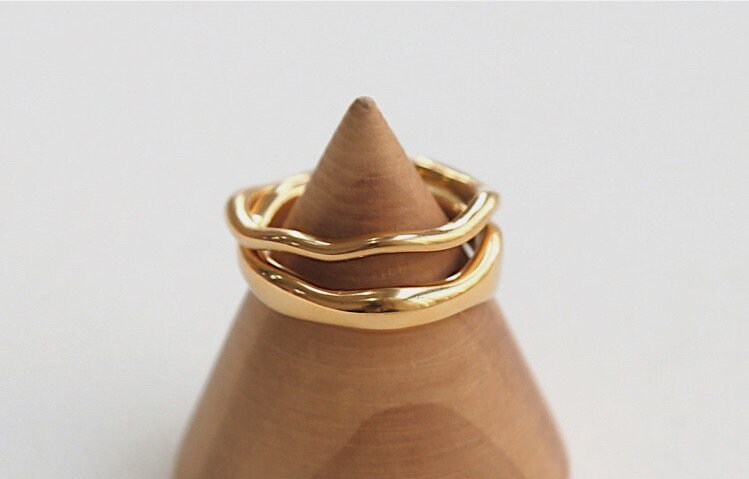 High polish reflective finish of a sculptural asymmetrical statement ring.