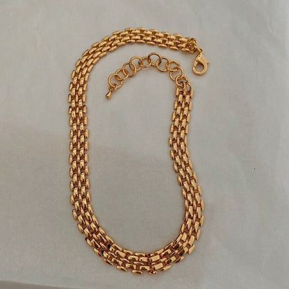 Sean panther link chain necklace displaying wide gold brick link profile on white surface