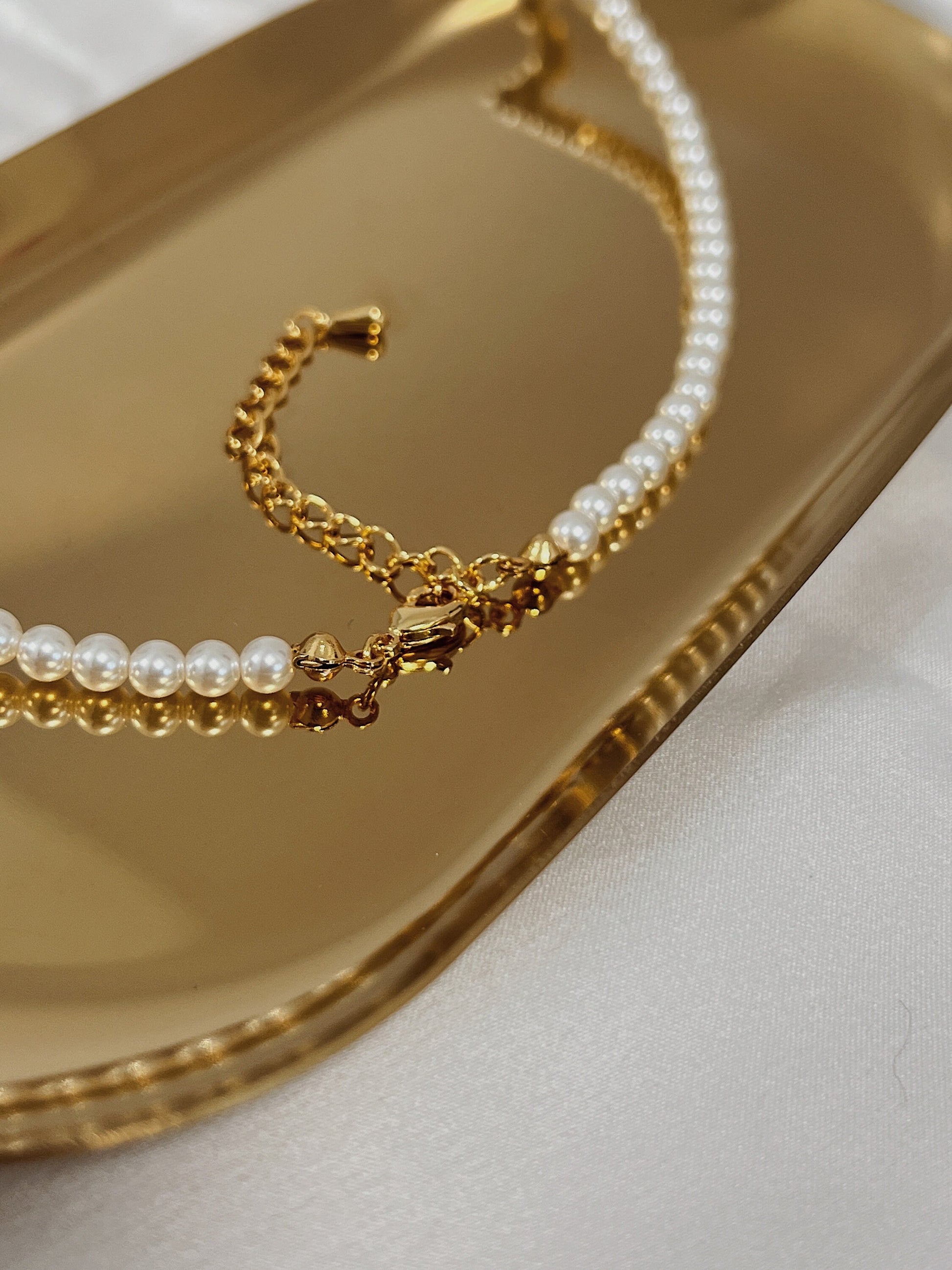 Elegant warm yellow gold extender chain displayed with delicate mini pearls loop assembly