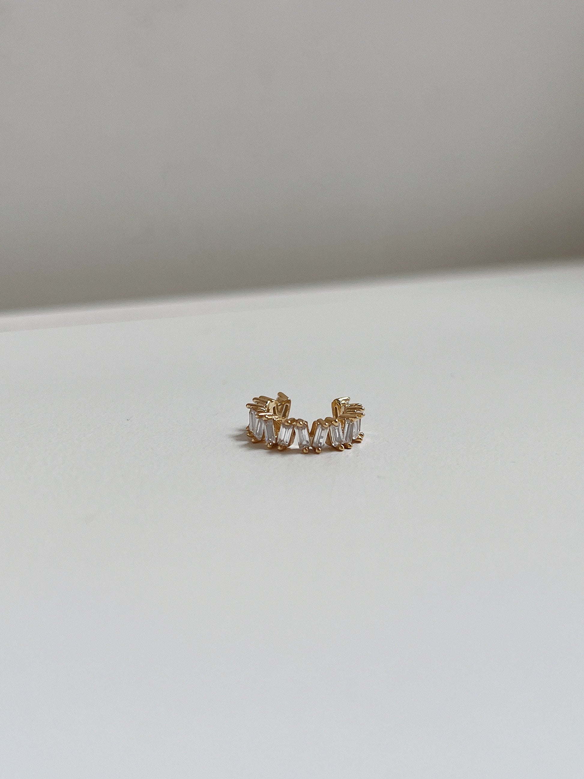 Front view of geometric gold baguette ear cuff.