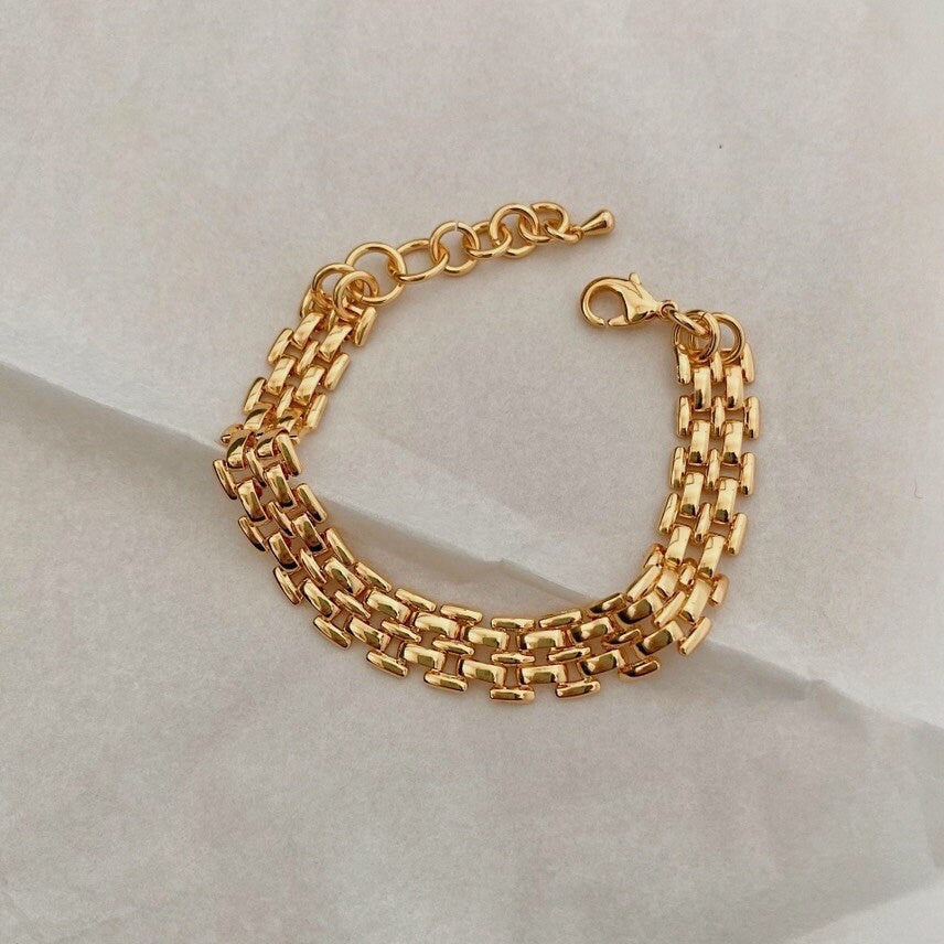 Close up view of high polish 18k gold PVD watch style bracelet links