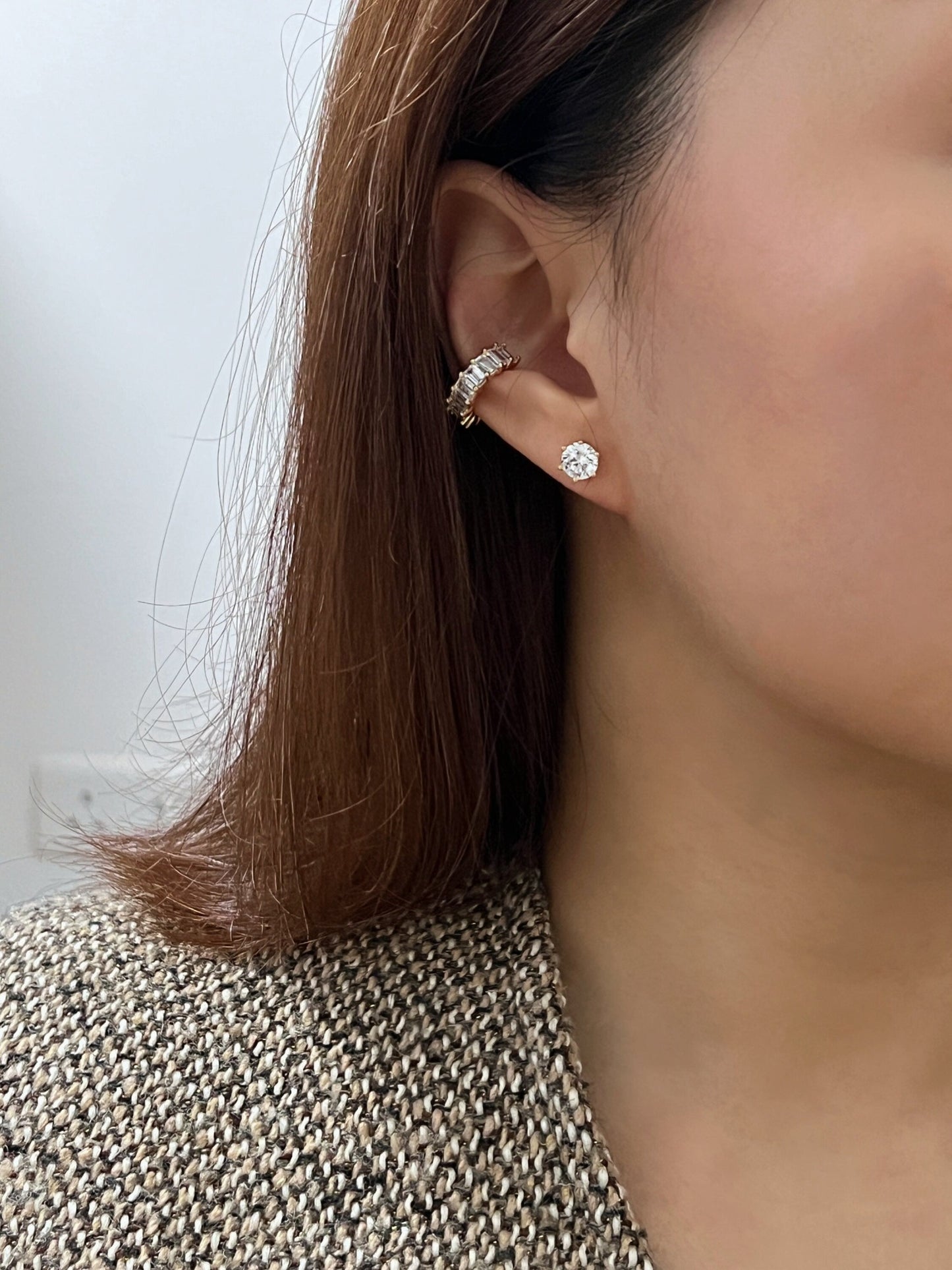 Lifestyle shot of a model styling the Aria cuff with gold minimalist studs