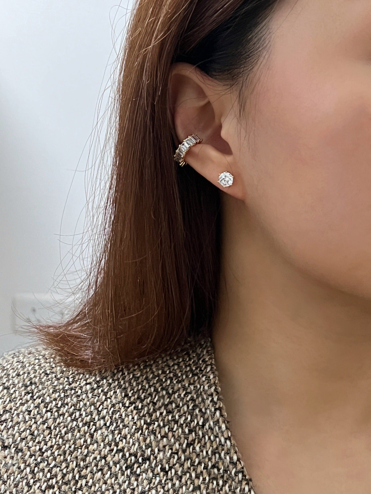 Lifestyle shot of a model styling the Aria cuff with gold minimalist studs