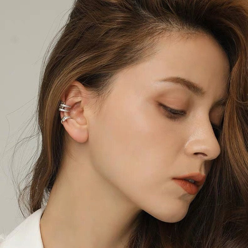 Side profile of a model featuring a curated stack with waterproof gold jewelry.