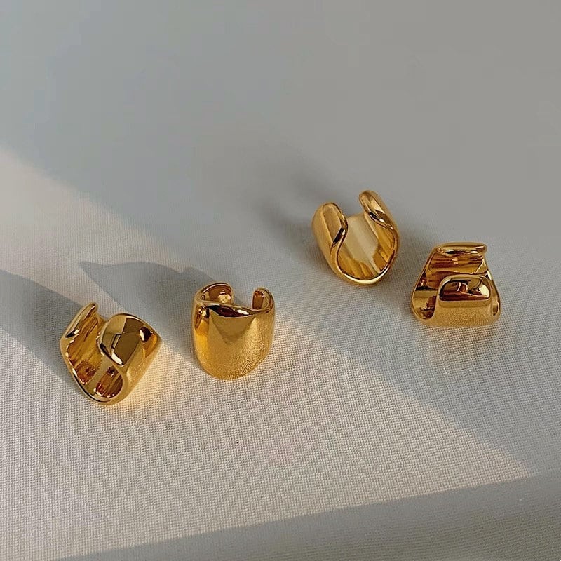 Close-up of sculptural wide cuff gold finish.