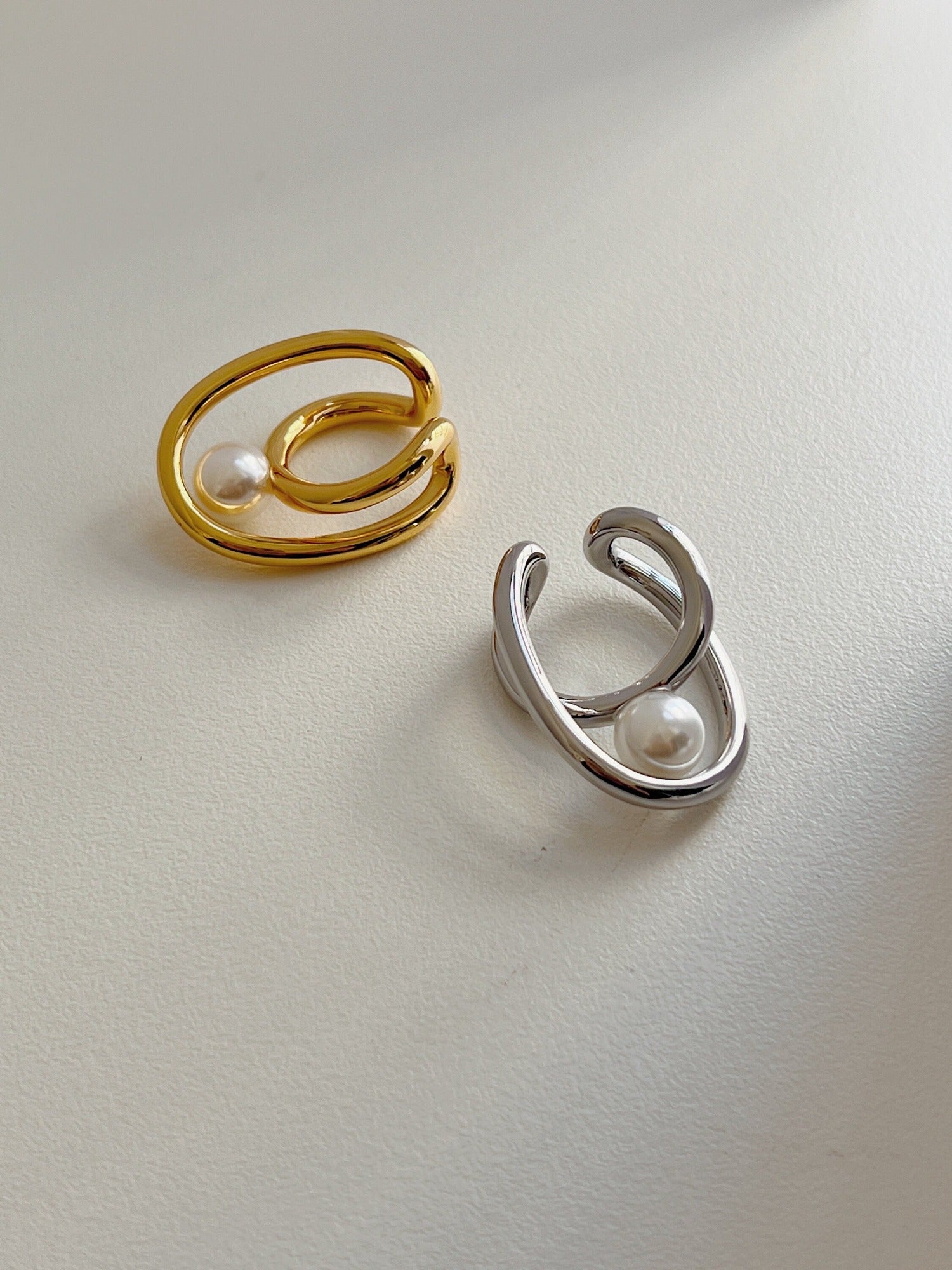 Close-up of the architectural fluid gold frame on the Karolina Cuff