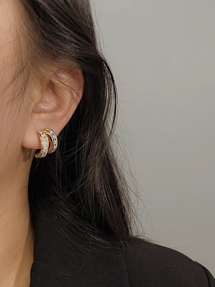 Close up of model ear showcasing non-pierced ear stack with Tiana princess cut clip-on earring