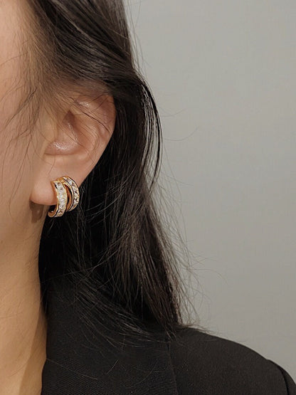 Close up of model ear showcasing non-pierced ear stack with Tiana princess cut clip-on earring