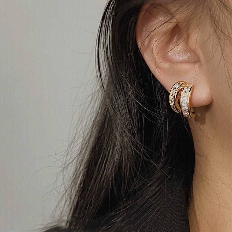 Close-up of a model's ear highlighting the "pierced illusion" of Tiana huggies.