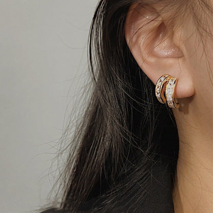 Close-up of a model's ear highlighting the "pierced illusion" of Tiana huggies.