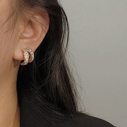 Close up shot showing comfortable fit of Tiana princess cut gold clip-on earring on unpierced earlobe