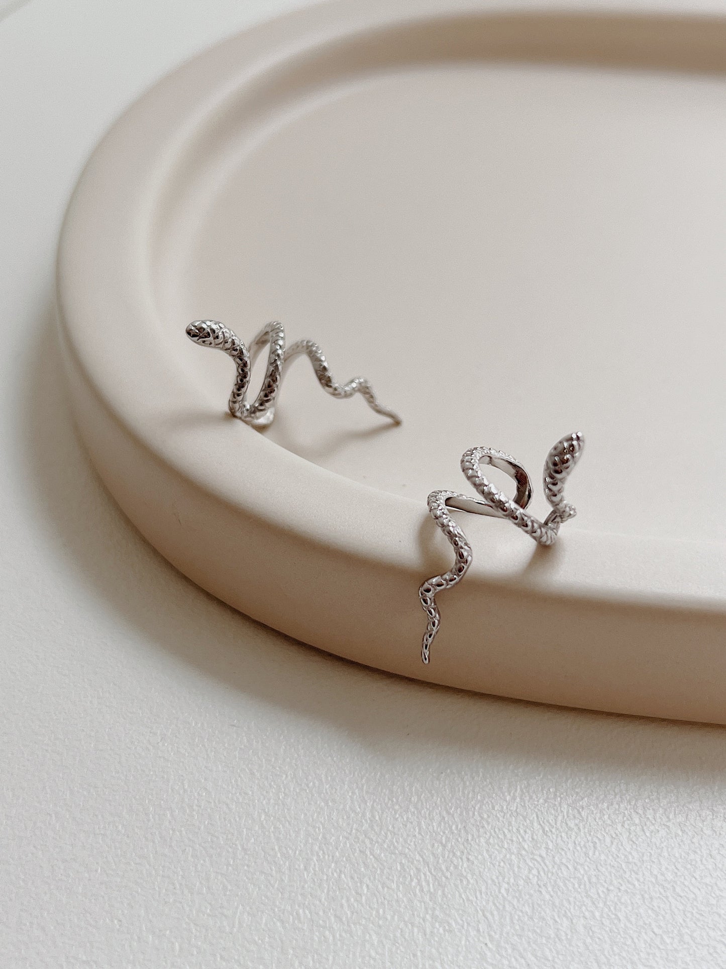 Side profile of Victoria coiling silver serpent cuff.