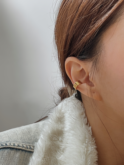 Model wearing the Elena ribbed cuff in the conch for a high-end triple stack look.