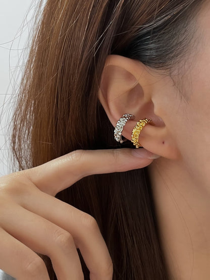 Close-up of model's ear showing the organic, sculptural fit of the Molten Ridge cuff.